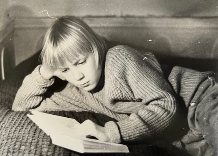 Silvo Lahtela als Junge, auf dem Bettein Buch lesend